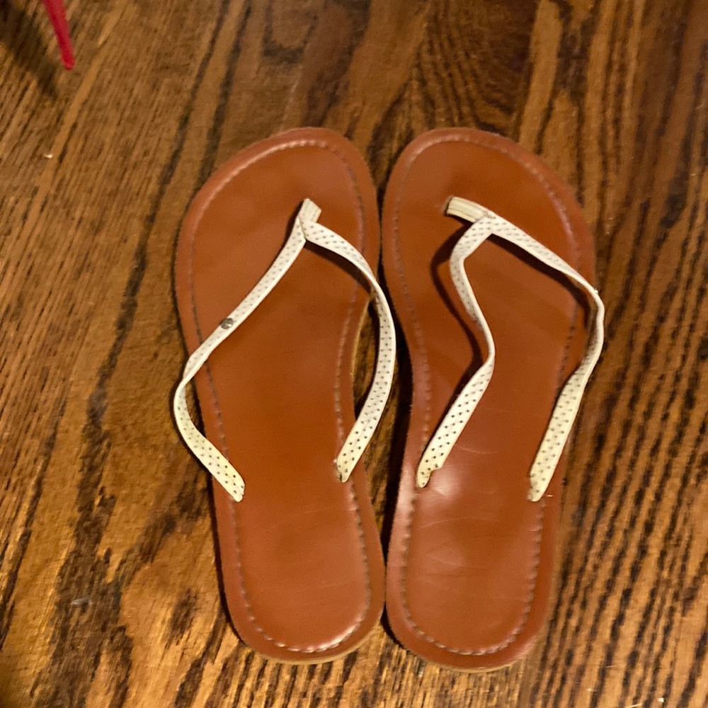 Tan/white target flip flops